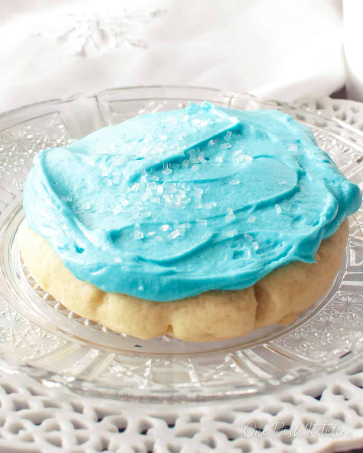 one soft frosted sugar cookie on a plate.