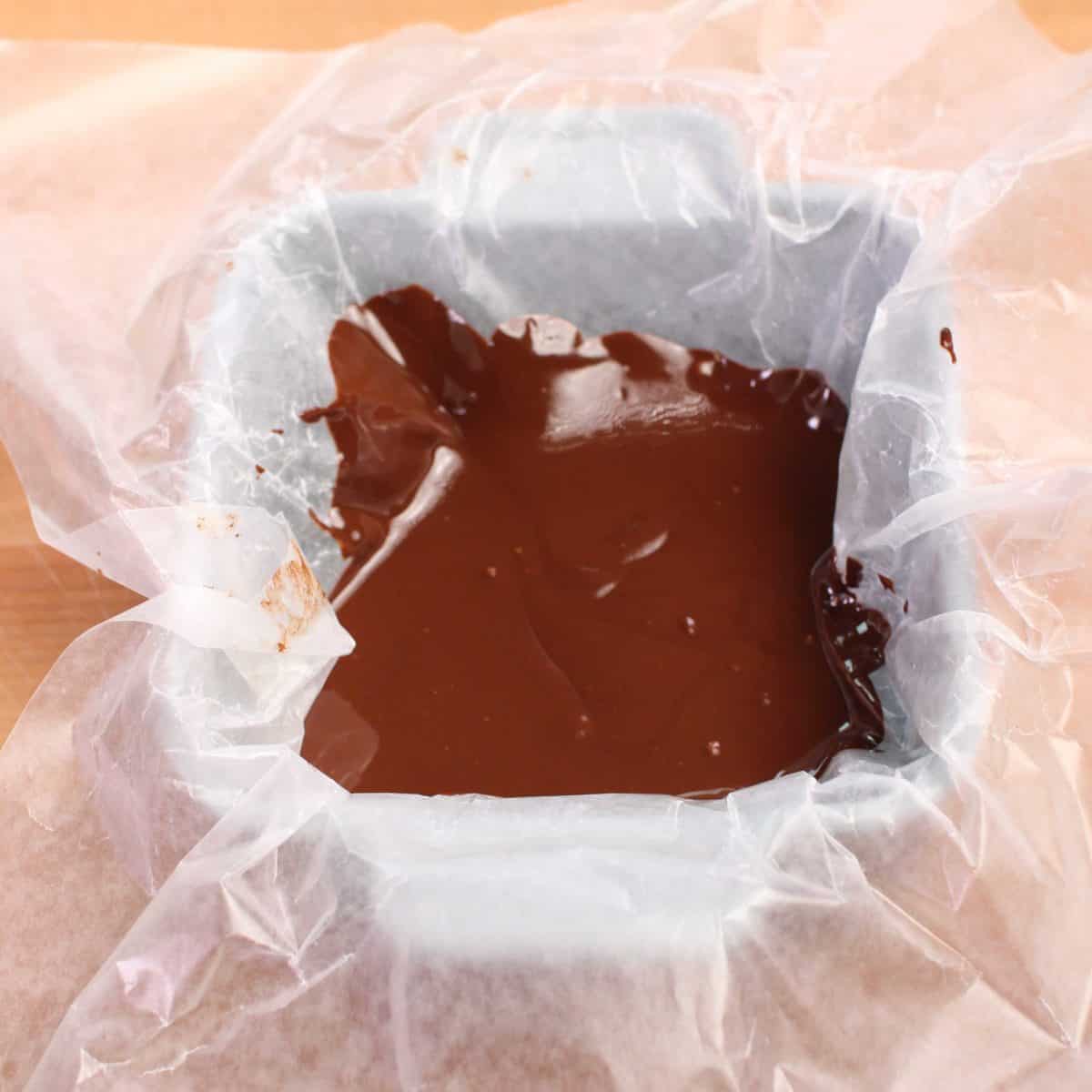 melted chocolate in a wax paper lined baking dish.