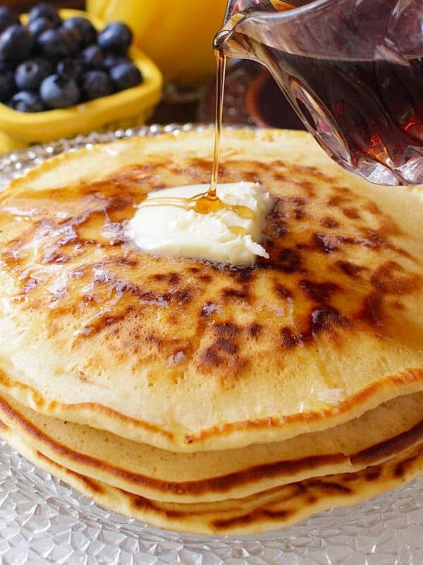 three pancakes on a plate made with homemade pancake mix, topped with butter and syrup.