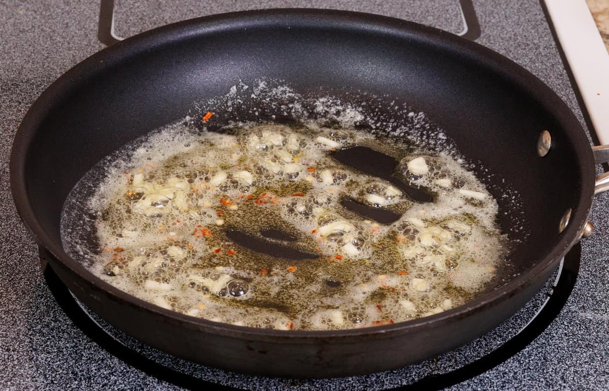 garlic cooking in butter in a skillet.