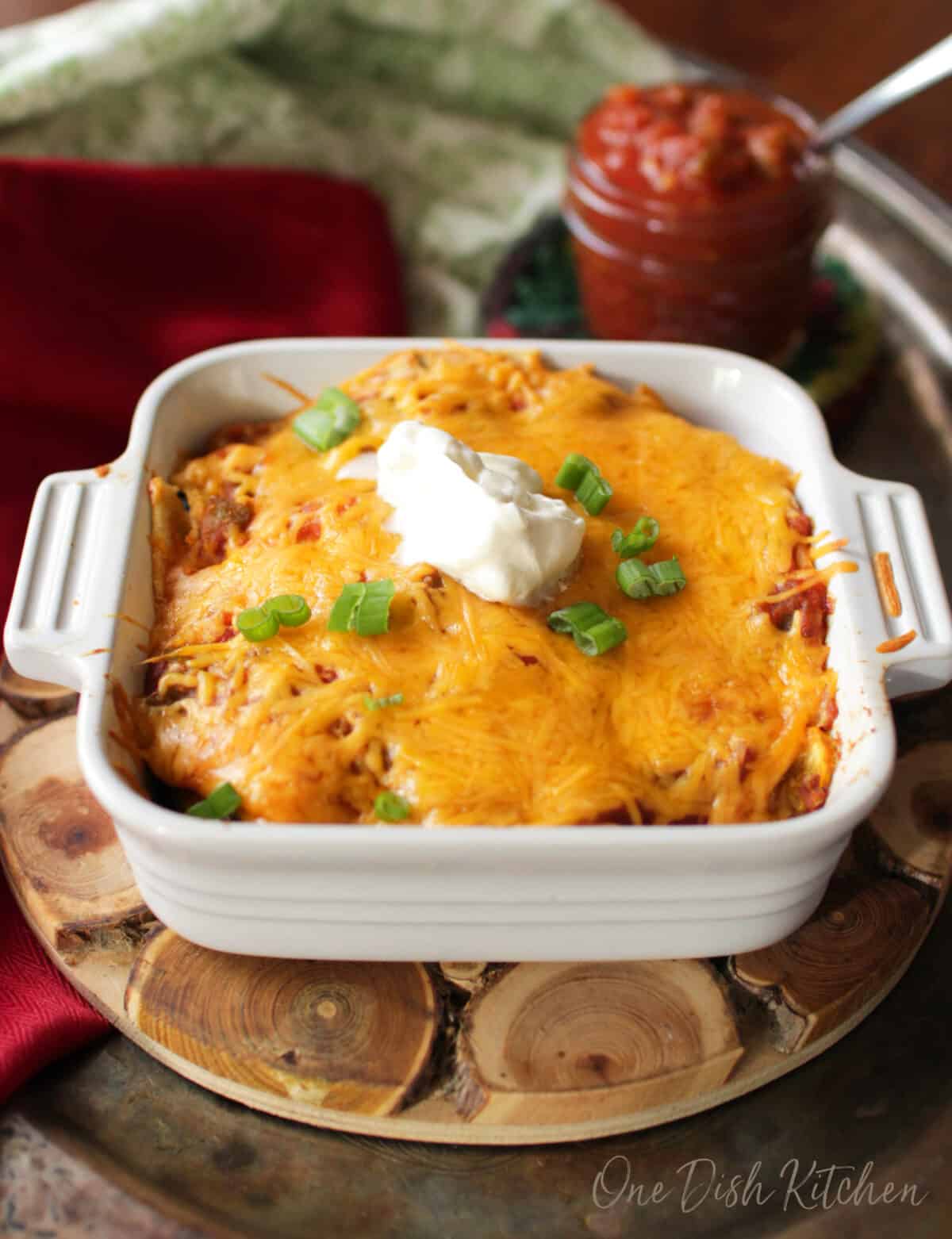 vegetarian enchiladas in a small baking dish on a kitchen table.