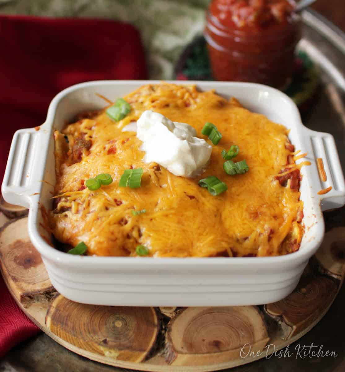 vegetarian enchiladas in a small baking dish on a kitchen table.
