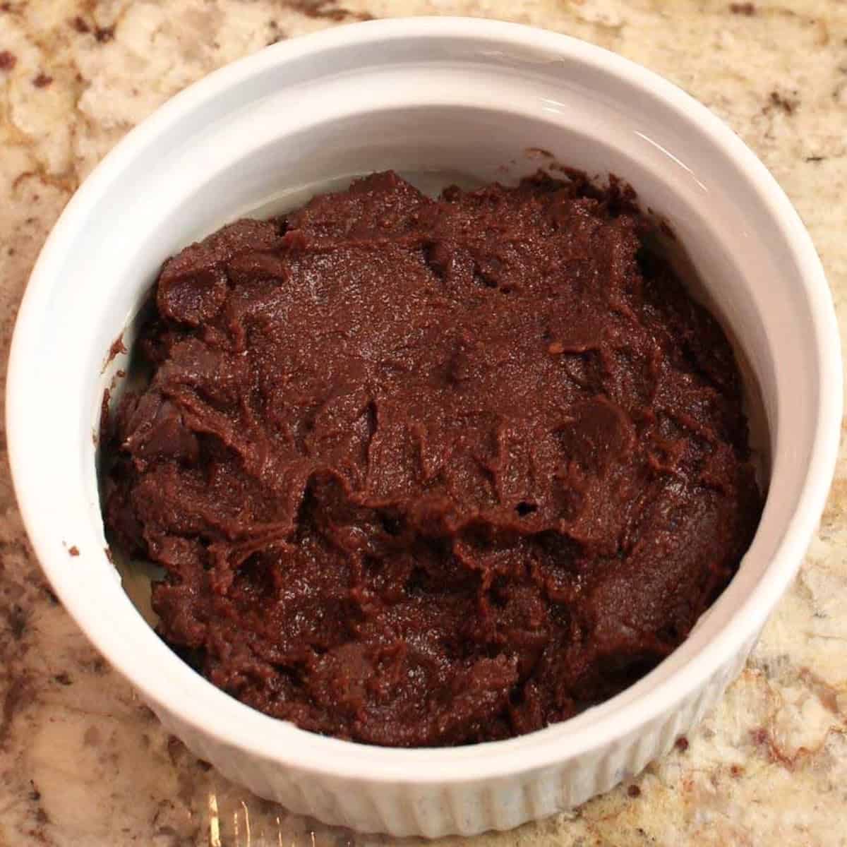 a single unbaked brownie in a ramekin.