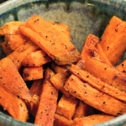 a single serving of sweet potato fries in a green bowl