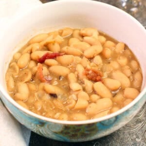 a bowl of white bean soup with bacon