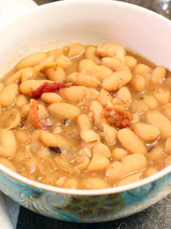 a bowl of white bean soup with bacon