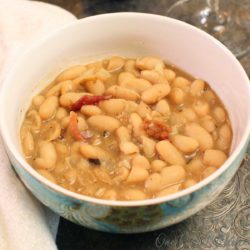 a bowl of white bean soup with bacon