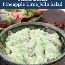 lime jello salad with crushed pineapples in a green bowl.