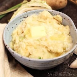 a bowl of colcannon topped with melted butter.