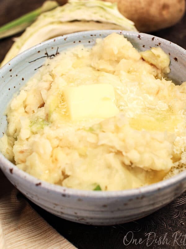 a bowl of colcannon topped with melted butter.