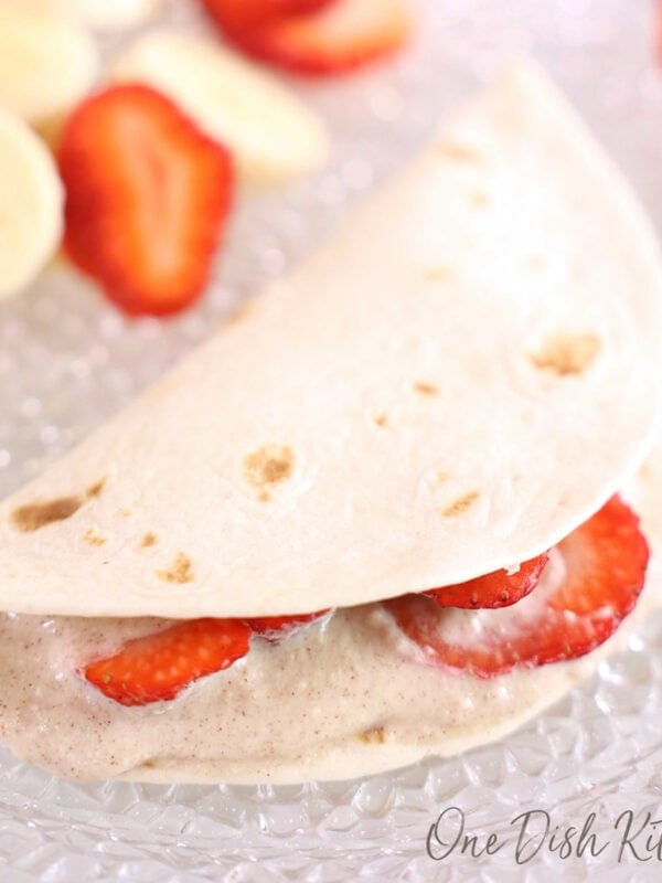 a single fruit quesadilla filled with sliced strawberries.