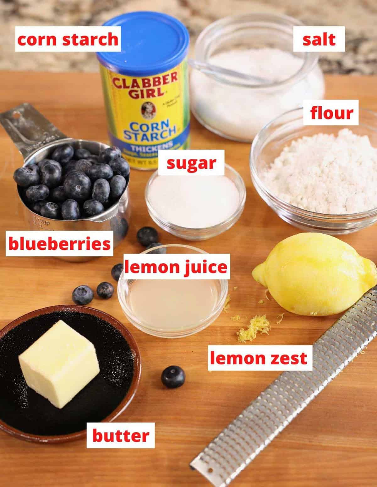 blueberry pie ingredients on a cutting board.