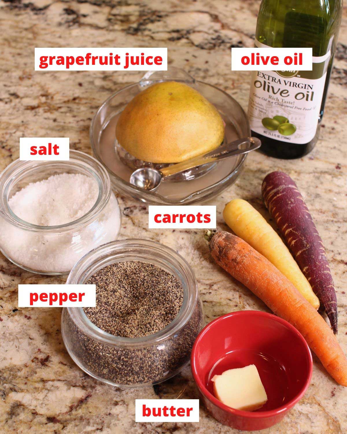 carrots, butter, salt, pepper, and juice on a brown countertop.