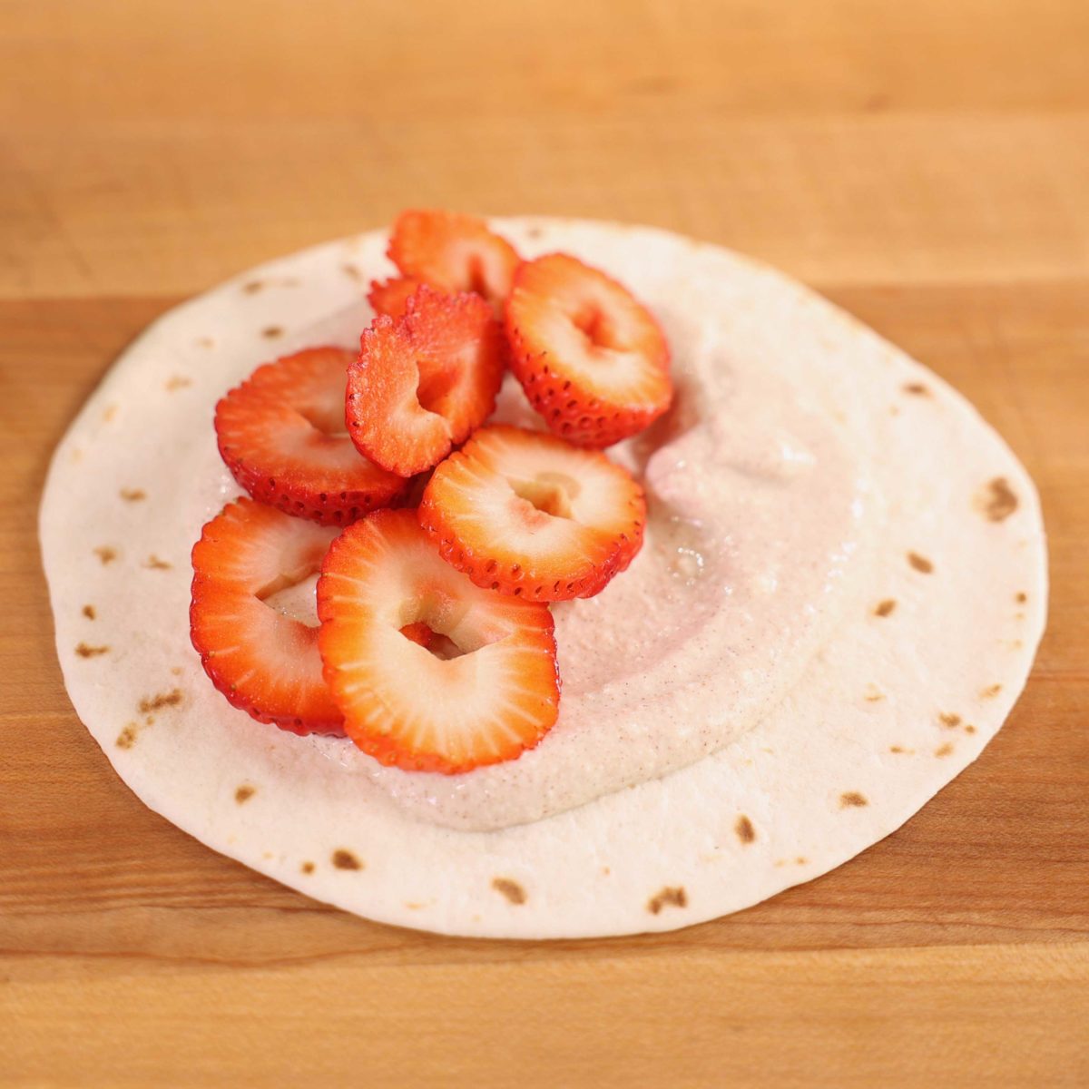 slices of strawberries on a tortilla