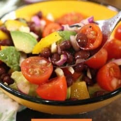 guacamole salad with a fork on the side of the bowl.