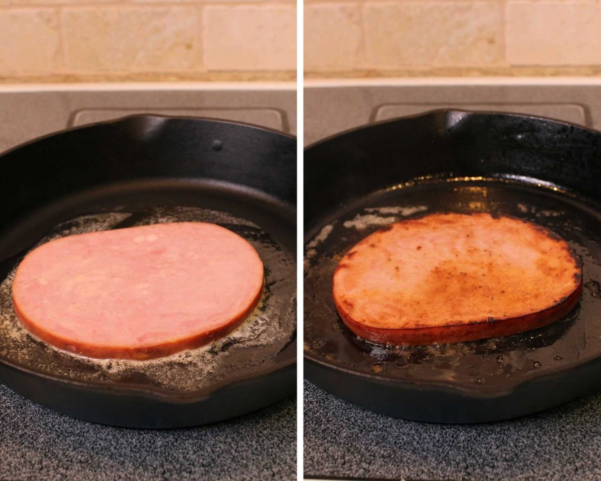 ham steak cooking in a cast iron skillet.