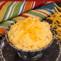 a bowl of cheese grits on a silver tray