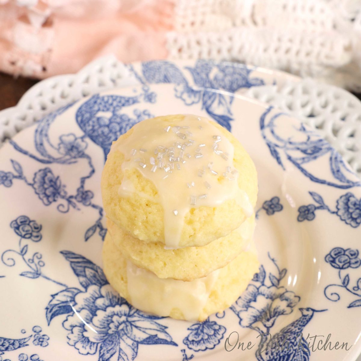 three ricotta cookies on a plate.