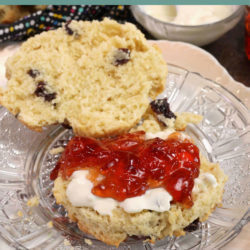 a scone topped with clotted cream and jam