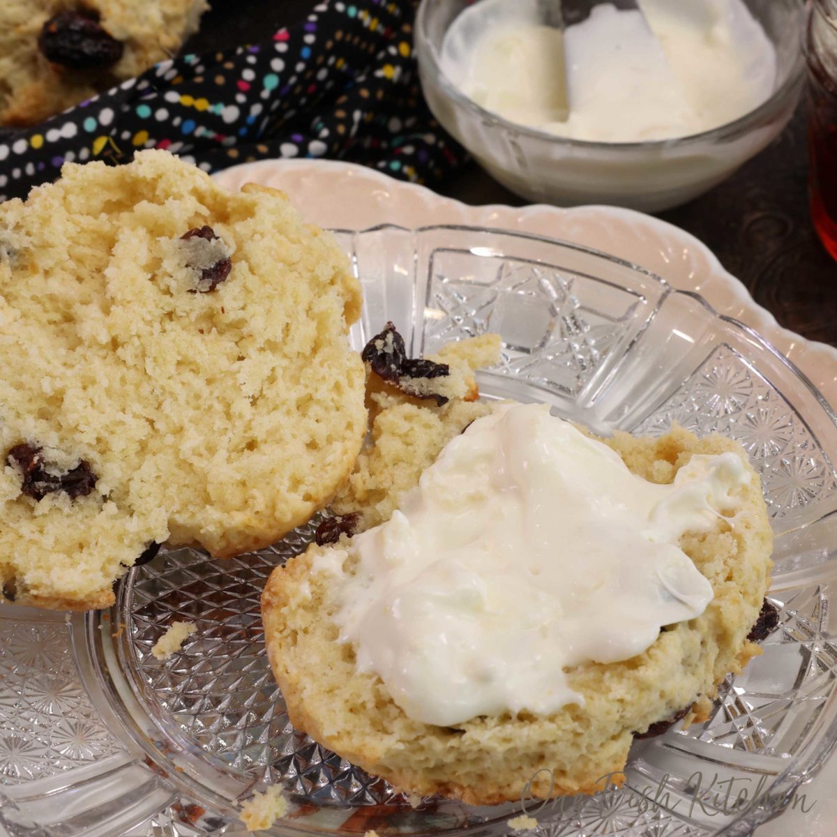 a raisin scone topped with clotted cream