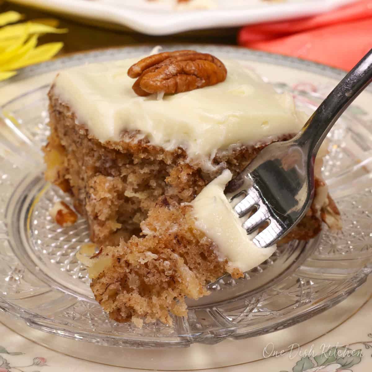 a slice of hummingbird cake on a plate with a fork on the side.