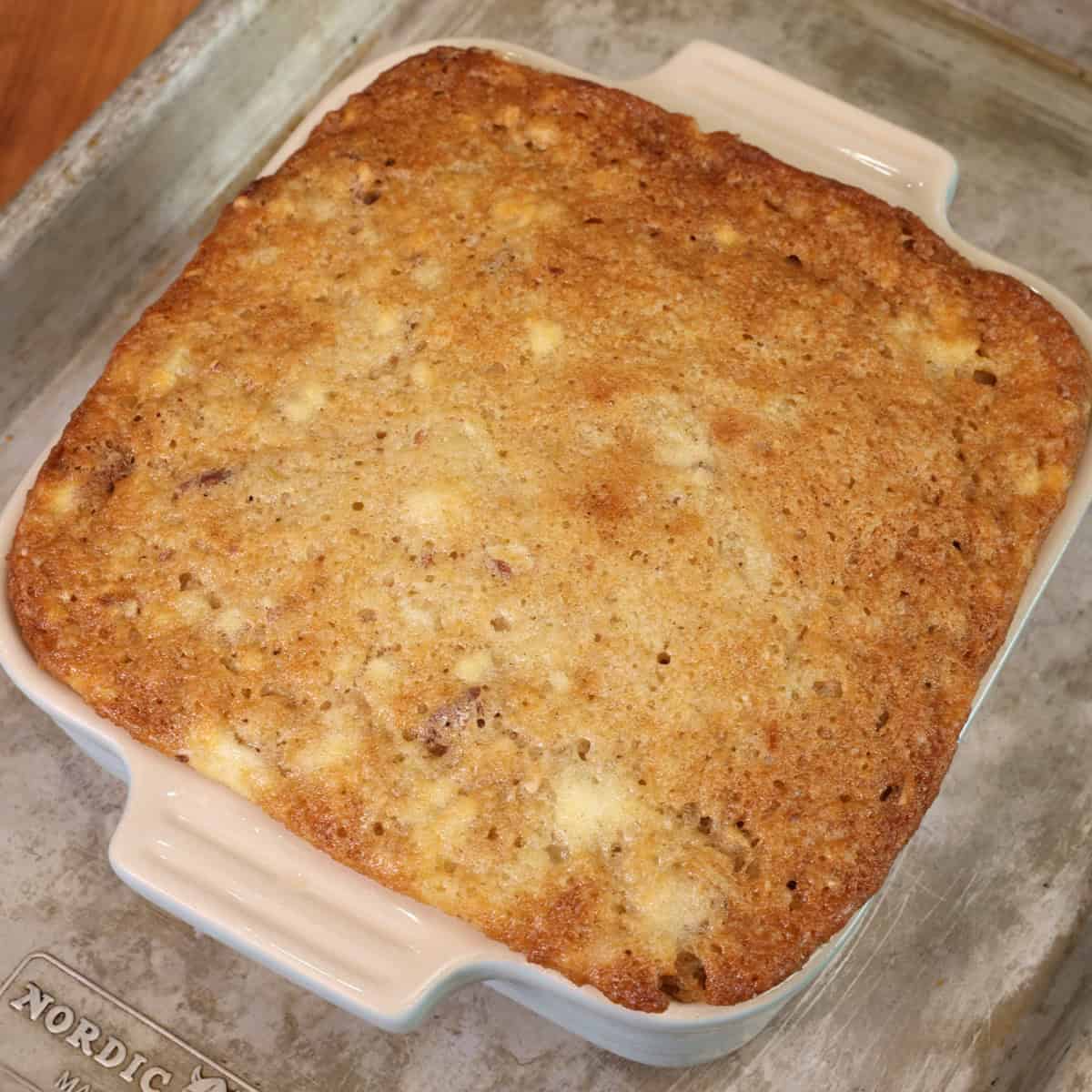 an unfrosted hummingbird cake on a baking sheet.