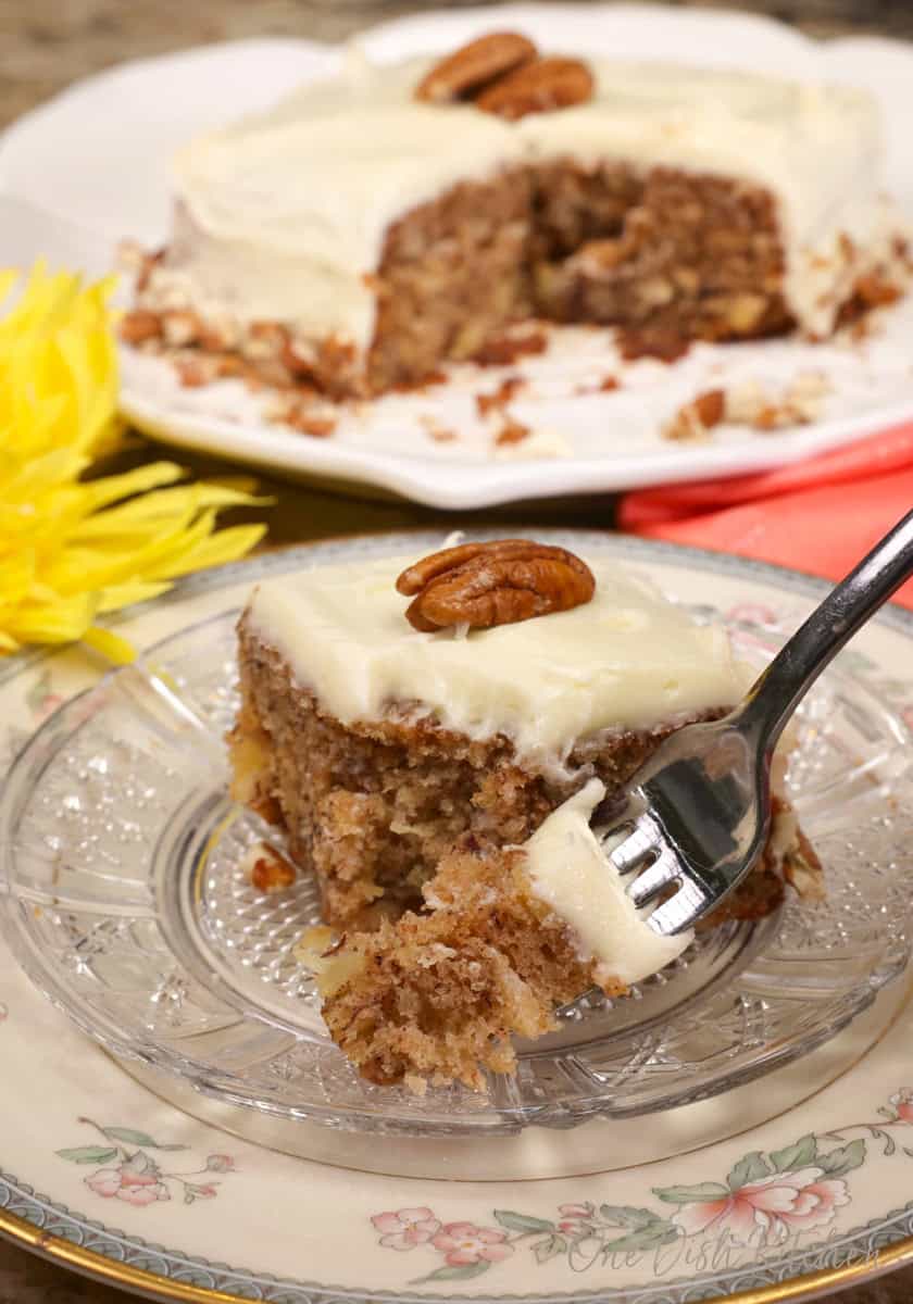 a slice of hummingbird cake on a plate with a fork on the side.