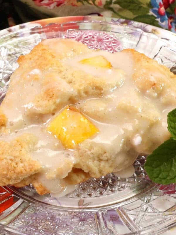 one peach scone on a plate.