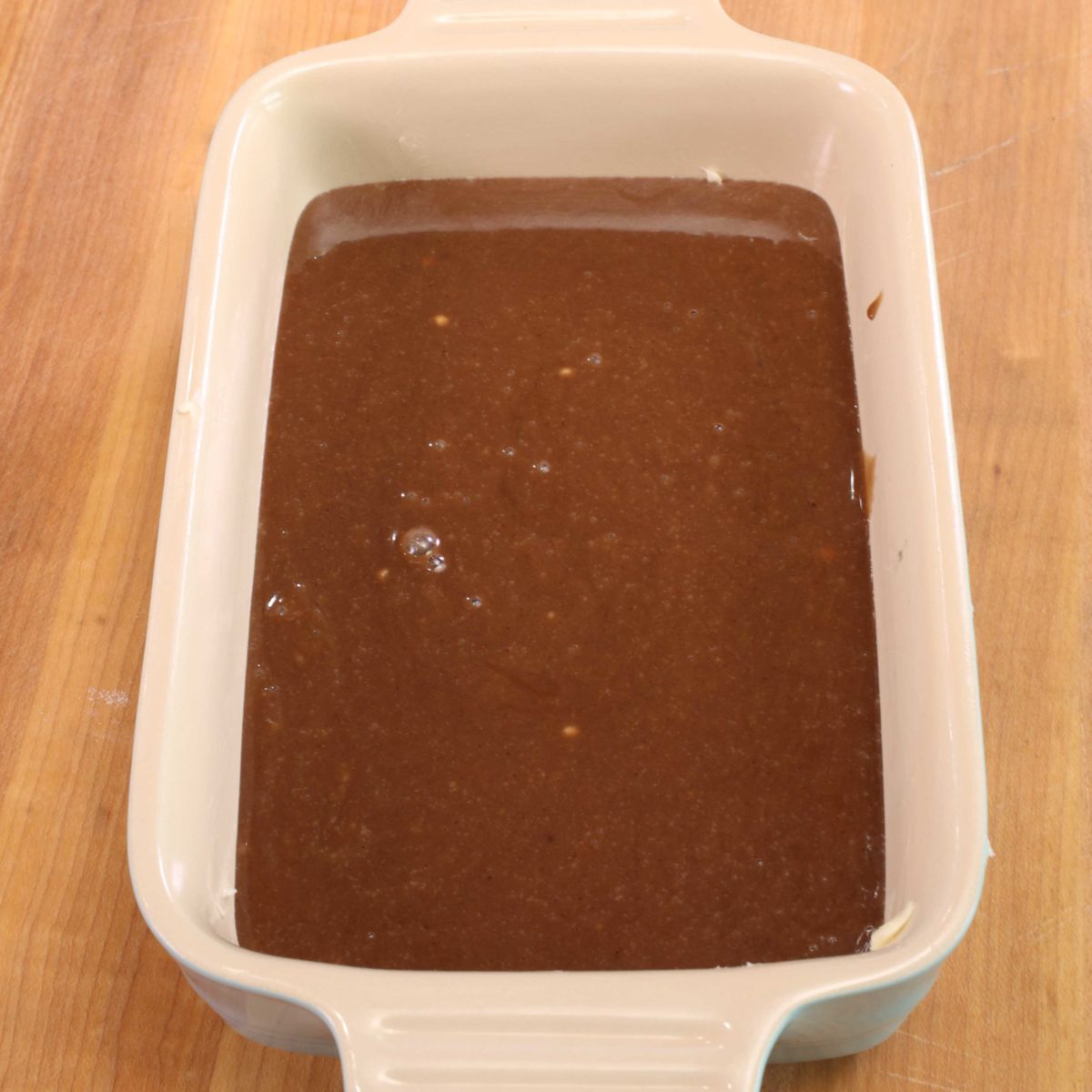chocolate cake batter in a 5x7 inch baking dish.