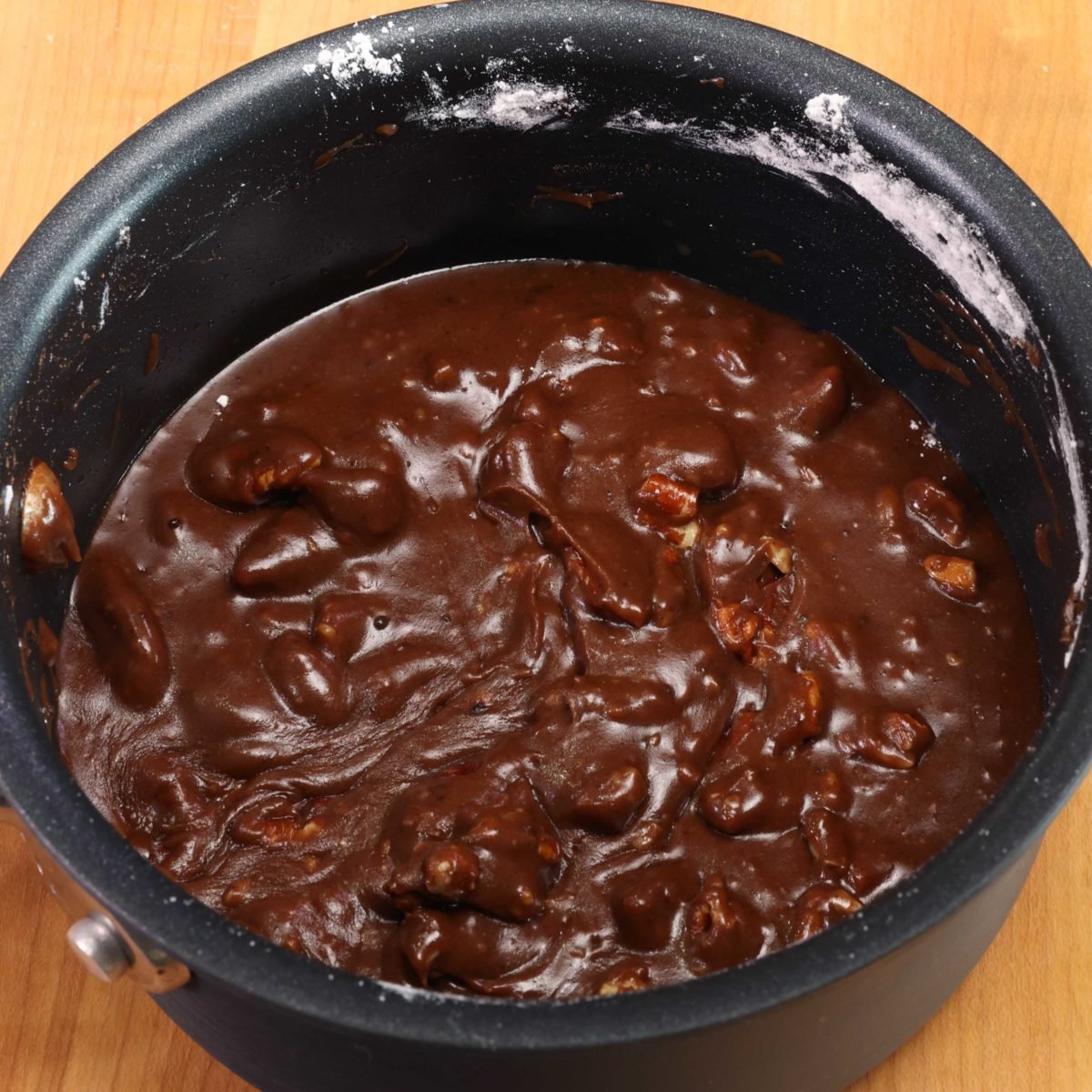 melted chocolate in a saucepan with nuts.