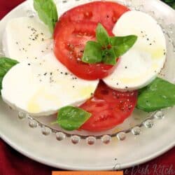 a caprese salad on a white plate.