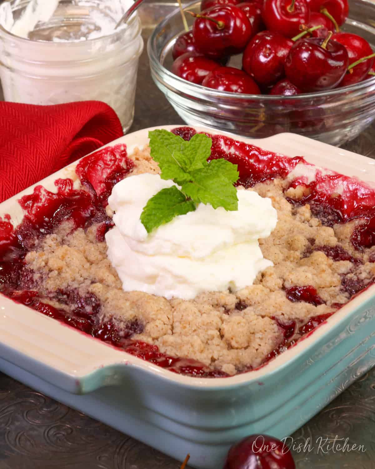 a single serving cherry pie in a square dish.