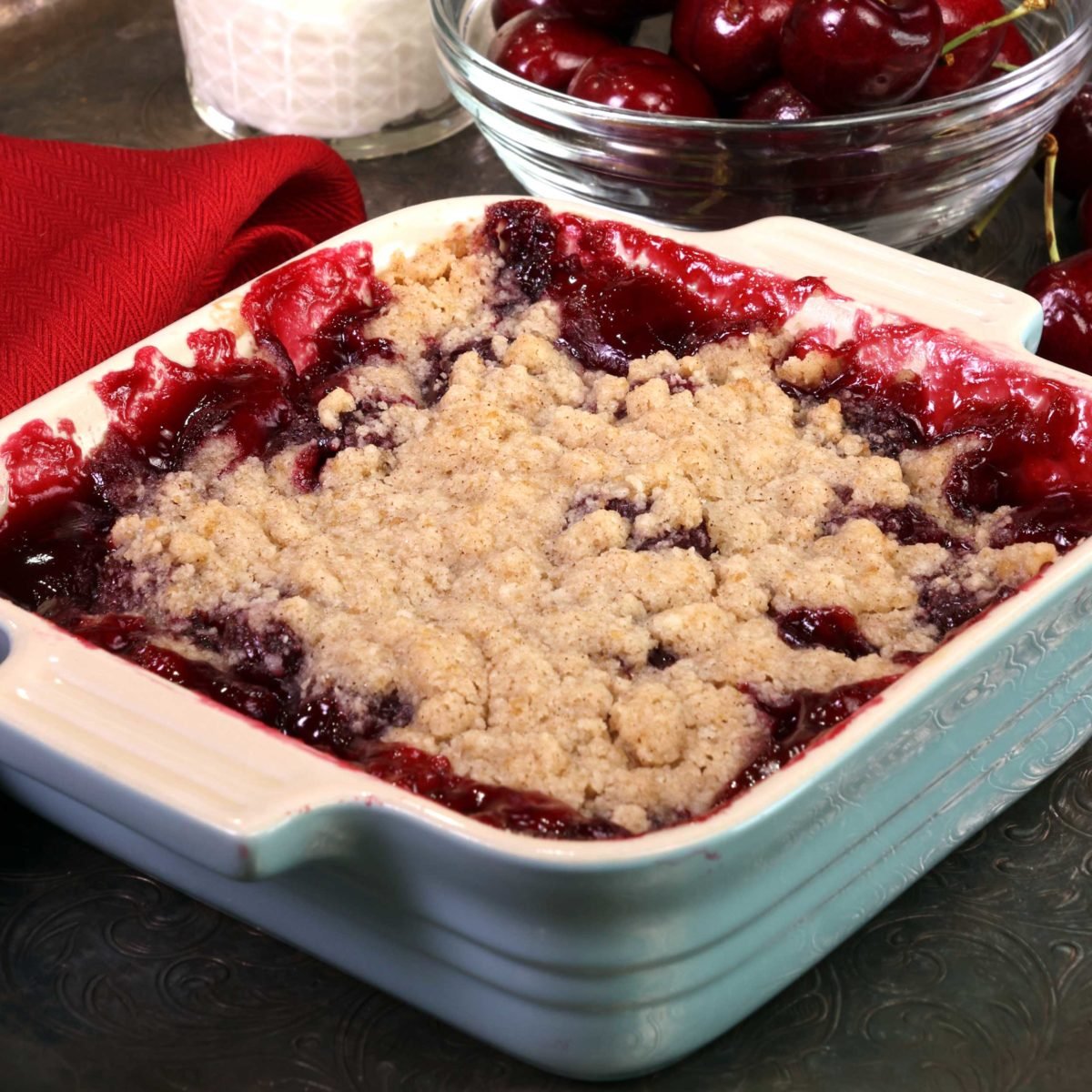 a single serving cherry pie in a square dish.