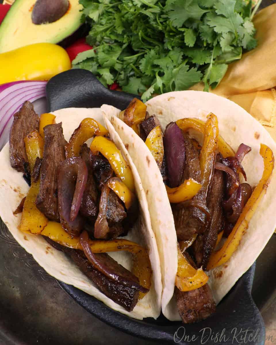 two tortillas filled with beef and peppers.