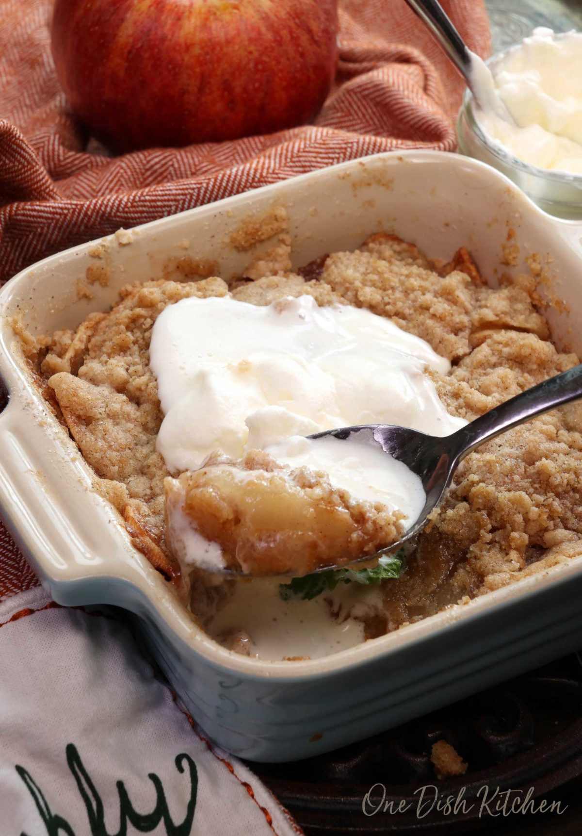 a mini dutch apple pie in a small baking dish with a spoonful of pie in the corner of the dish.