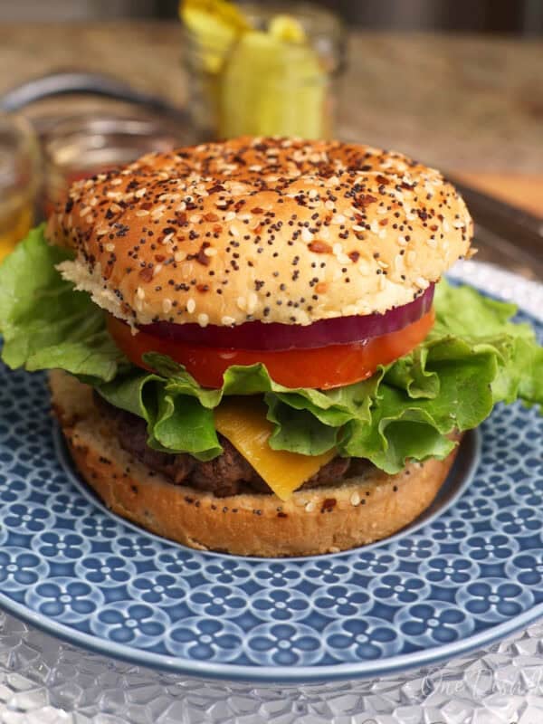 a single hamburger on a blue plate.