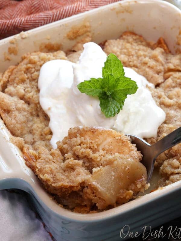 a small dutch apple pie in a square blue baking dish.