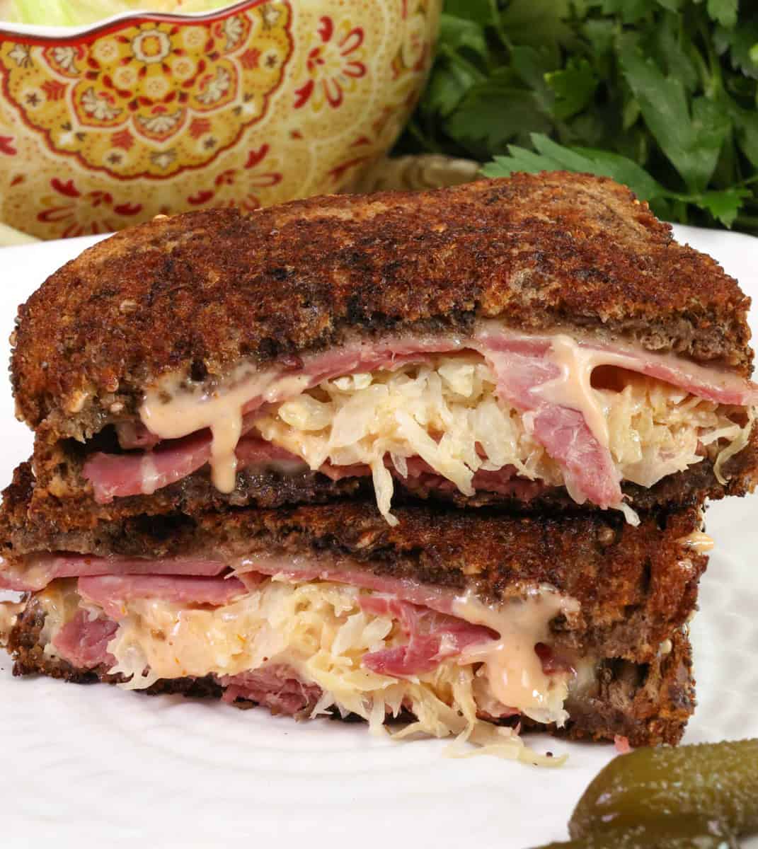 a reuben sandwich sliced in half.