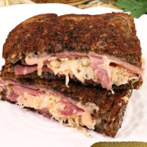 a reuben sandwich on a white plate.