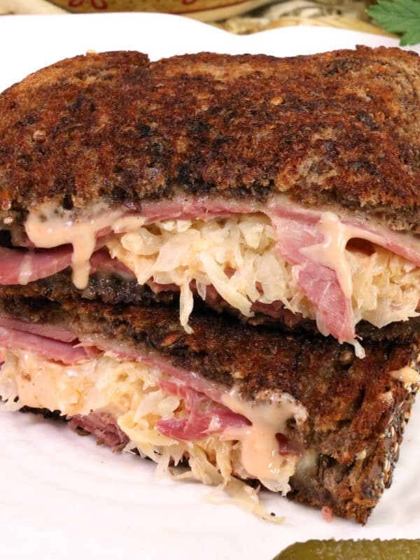 a reuben sandwich on a white plate.