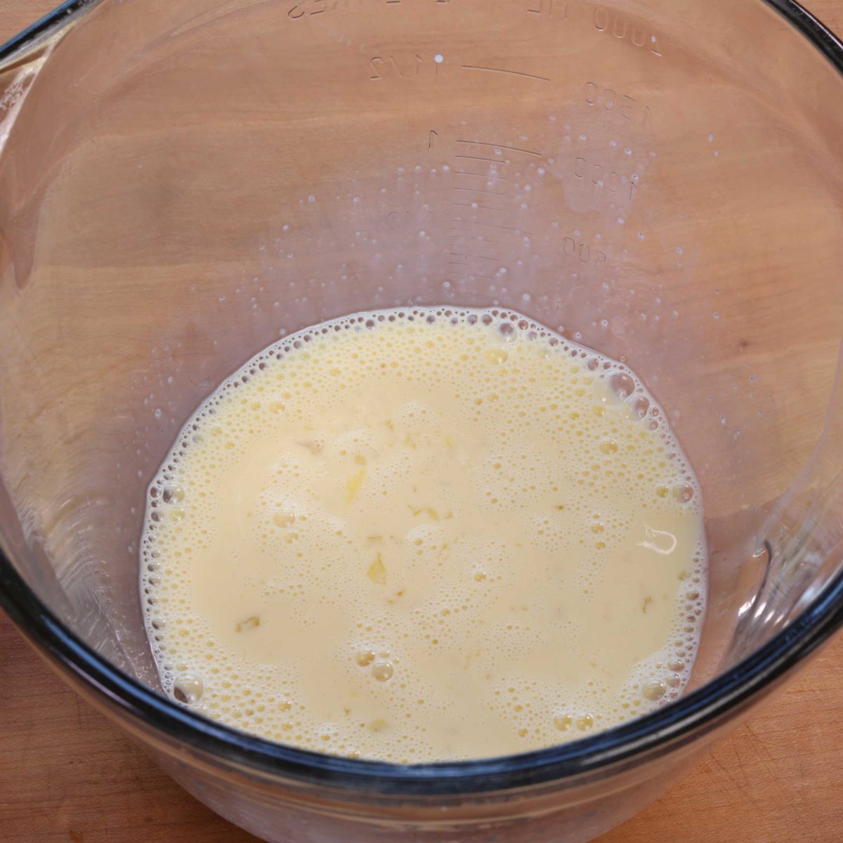 egg, milk, and sugar whisked together in a mixing bowl.