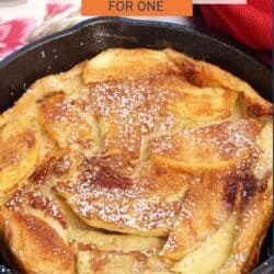 an apple dutch baby in a cast iron skillet.