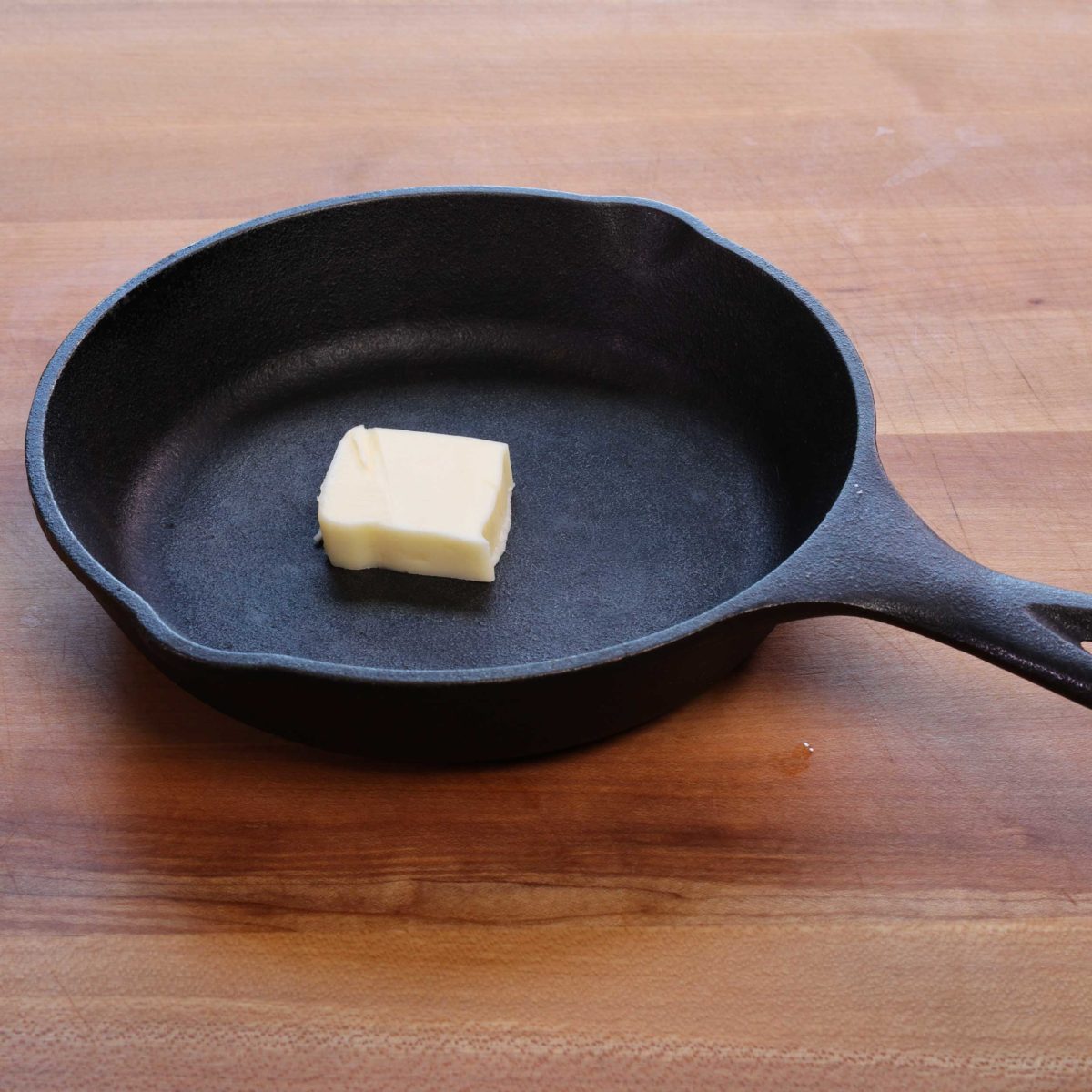 a small cast iron skillet with butter in the center.