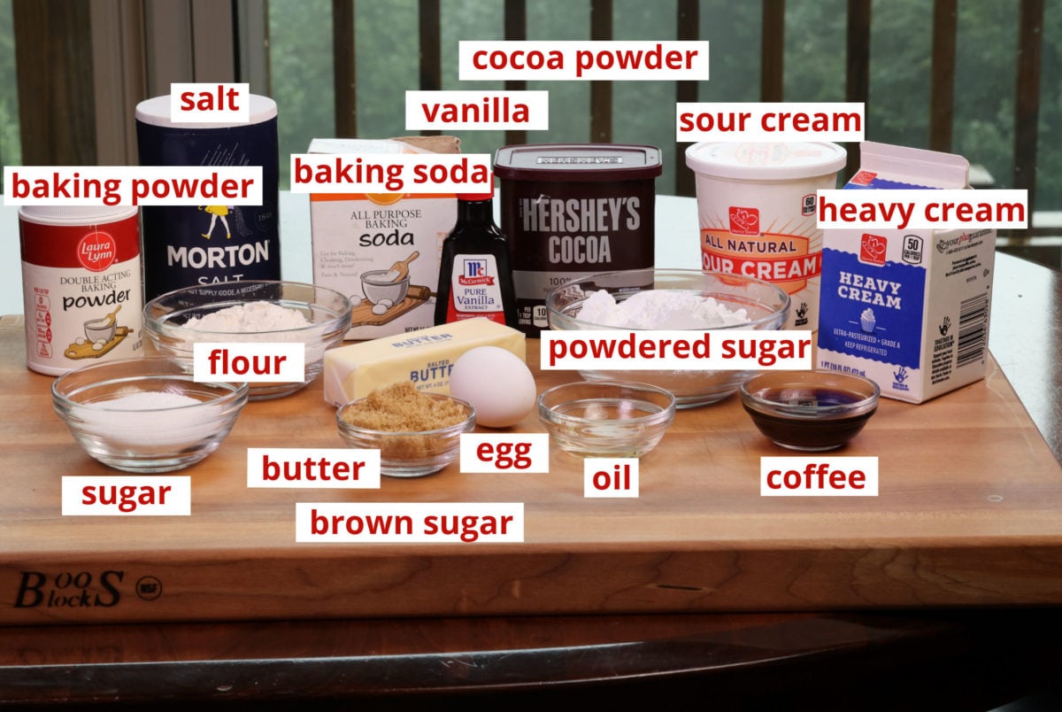 ingredients needed to make a devils food cake on a wooden cutting board.