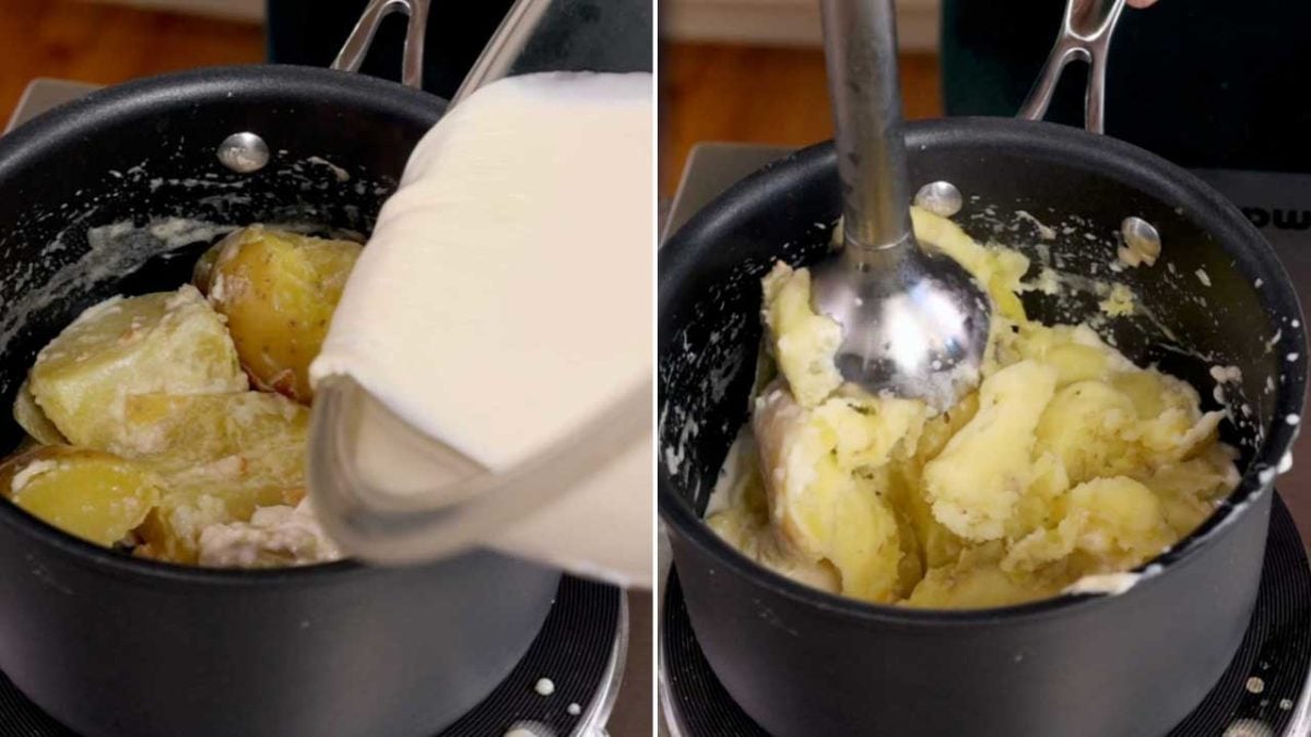 pouring cream over cooked potatoes in a small black pot