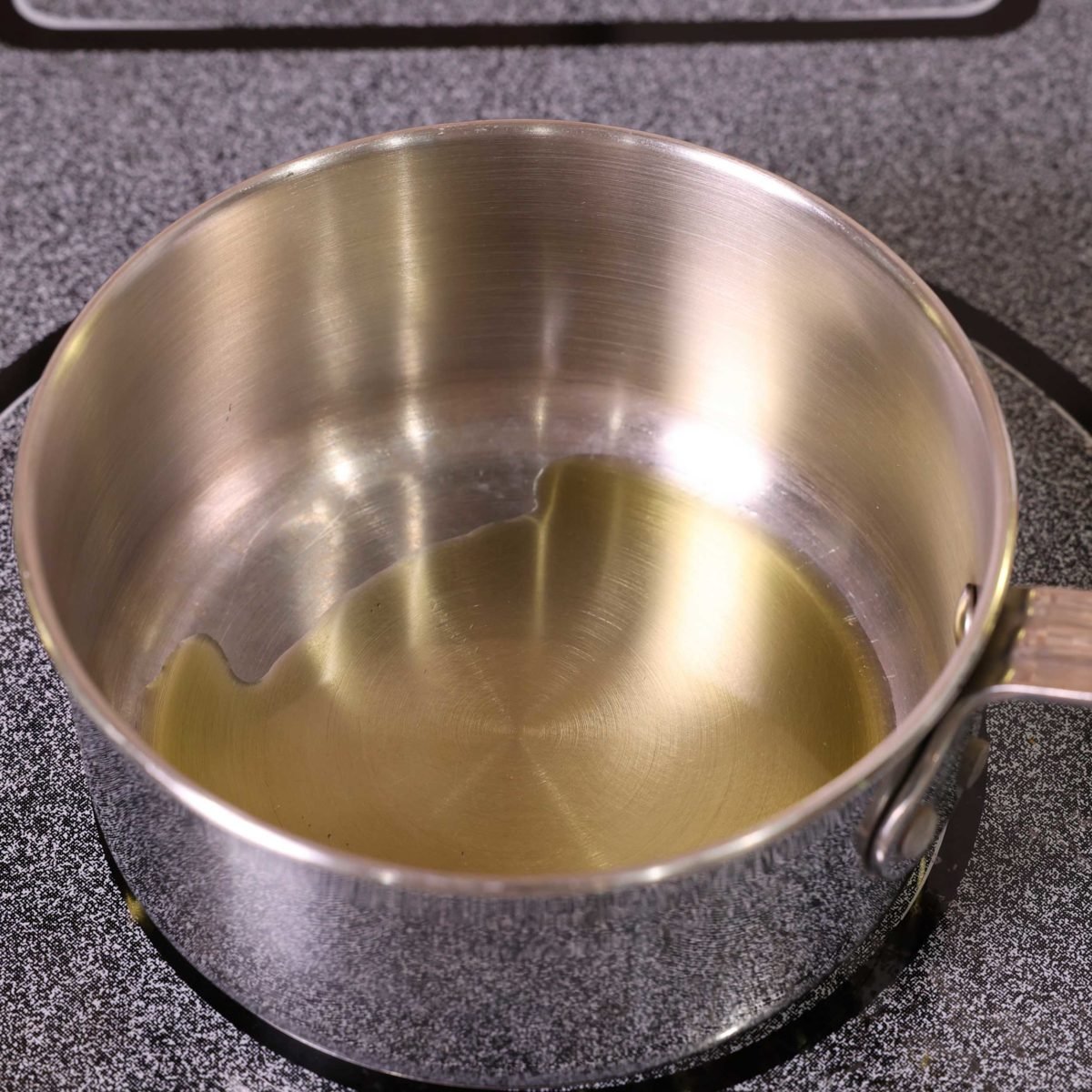 olive oil heating in a small saucepan.