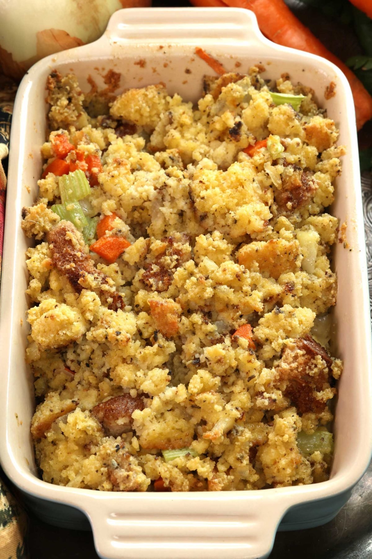baked cornbread dressing in a small blue baking dish.