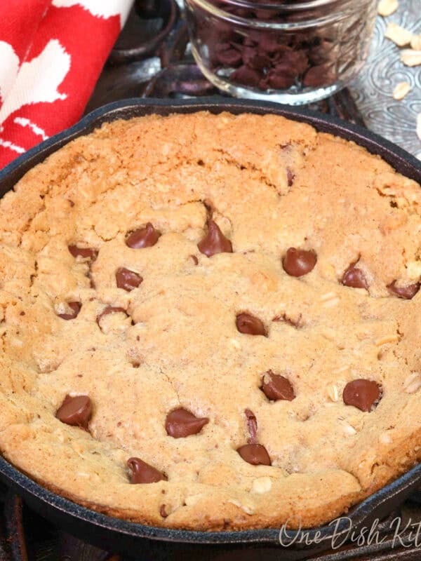 a mini oatmeal chocolate chip skillet cookie in a small cast iron skillet.