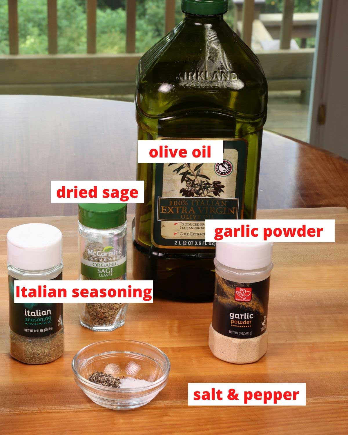 seasonings and olive oil on a wooden cutting board in a kitchen.