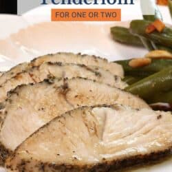 slices of cooked turkey tenderloin on a plate with green beans.